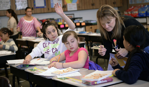 Al Hartmann  |  The Salt Lake Tribune
Bennion Elementary School fifth-grade teacher Lynette Miller gets plenty of questions from students in a critical thinking and writing problem. She works in the Advancement Via Individual Determination (AVID) program at the school. The program is designed to get students thinking at an early age of completing a degree at a four-year college.