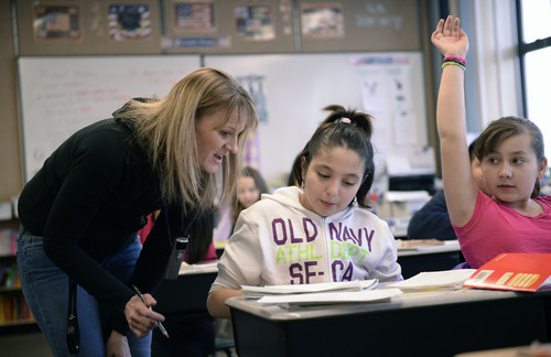 Al Hartmann  |  The Salt Lake Tribune
Bennion Elementary School fifth-grade teacher Lynette Miller helps Jennifer Calderon and Lizzy Stolenberg in a critical thinking and writing problem.  She works in the Advancement Via Individual Determination (AVID) program at the school. The program is designed to get students thinking at an early age of completing a degree at a four-year college.