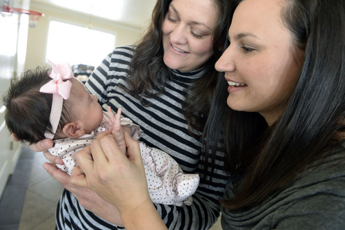 Francisco Kjolseth  |  The Salt Lake Tribune
Newly married couple Amber Whiteaker, center, and her wif,e Robin Brown, hold their daughter Paige, 7 weeks, during a visit to their home in Centerville on Sunday, Dec. 29, 2013. Hundreds of same-sex couples have wed since a federal judge struck down Utah's gay marriage ban. For many of the newlyweds' parents, it's a milestone they never thought they'd see their children reach.