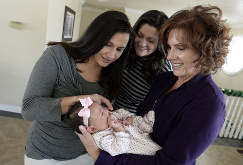 Francisco Kjolseth  |  The Salt Lake Tribune
Bonnie Whiteaker holds her granddaughter Paige, 7 weeks, alongside her daughter Amber, center, and daughter-in-law Robin Brown, during a visit to their home in Centerville on Sunday, Dec. 29, 2013. Hundreds of same-sex couples have wed since a federal judge struck down Utah's gay marriage ban Dec. 20. For many of the newlyweds' parents, it's a milestone they never thought they'd see their children reach.