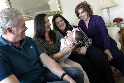 Francisco Kjolseth  |  The Salt Lake Tribune
Paige Whiteaker, 7 weeks, is the center of attention from her mothers, Robin Brown, center left, and Amber Whiteaker during a visit to their Centerville home from Amber's parents, John and Bonnie Whiteaker, on Sunday, Dec. 29, 2013. The two, who have been together for four years, were married on Christmas Eve. Hundreds of same-sex couples have wed since a federal judge struck down Utah's gay marriage ban. For many of the newlyweds' parents, it's a milestone they never thought they'd see their children reach.