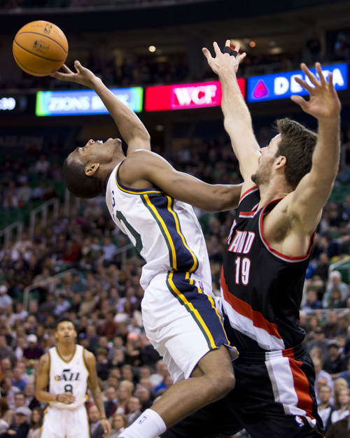 Lennie Mahler  |  The Salt Lake Tribune
Utah Jazz guard Alec Burks draws a foul from Joel Freeland on his way to the basket in the first half of a game against the Portland Trailblazers on Monday, Dec. 9, 2013.