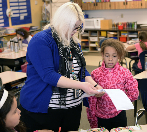 Al Hartmann  |  The Salt Lake Tribune
Bennion Elementary School fourth-grade teacher Carly Winslow helps Patience Durden through a spelling excercise. The class works in the Advancement Via Individual Determination (AVID) program at the school.   The program is designed to get students thinking at an early age of completing a degree at a four-year college.