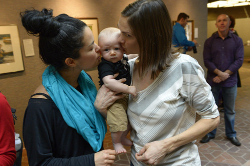Francisco Kjolseth  |  The Salt Lake Tribune
Danielle Torres, left, and her partner of 7-years,  Jody Jones kiss their son Franti Torres-Jones, 3-months, after being married in the lobby of the Salt Lake County offices on Monday, Dec. 23, 2013. Hundreds of same-sex couples descended on county clerk offices to request marriage licenses. A federal judge in Utah struck down the state's ban on same-sex marriage last Friday, saying the law violates the U.S. Constitution's guarantees of equal protection and due process.