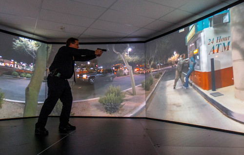 Trent Nelson  |  The Salt Lake Tribune
Unified Police Range Master Nick Roberts confronts a man holding a knife to a woman's neck while demonstrating a new five-screen training simulator used to put officers through realistic situations in Salt Lake City, Thursday November 7, 2013.