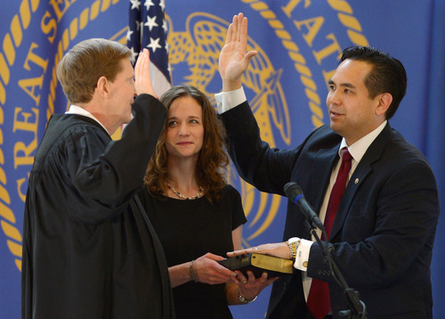 Steve Griffin  |  The Salt Lake Tribune

Saysha Reyes holds the Bible as her husband, Sean Reyes, is sworn in as attorney general by Utah Supreme Court Chief Justice Matthew B. Durrant at the Utah State Capitol Rotunda in Salt Lake City Monday, Dec. 30, 2013.