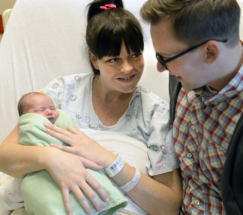 Al Hartmann  |  The Salt Lake Tribune
Heather and Matt Mildenstein of Provo hold their newborn daughter May Shellly Mildenstein who was born at Timpanogos Regional Hospital in Orem three seconds after midnight January 1 2014.