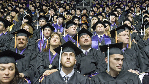 Paul Fraughton | The Salt Lake Tribune.
Students graduating at Weber State University look up at video monitors as they listen to the commencement exercises held at the Dee Events Center.
 Friday, April 20, 2012
