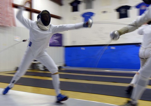 Leah Hogsten  |  The Salt Lake Tribune
Fencer Tatijana Stewart, 14,  of Pleasant View scores a point against her opponent coach Kenny Nopens at the Will Fence for Food fencing tournament that generated some $1800 in food and cash donations for food banks in Davis County, Saturday, January 4, 2014.
. For the tenth year, in lieu of entry fees, fencers from Utah and Idaho donate canned goods and cash of which all is donated to local food banks.