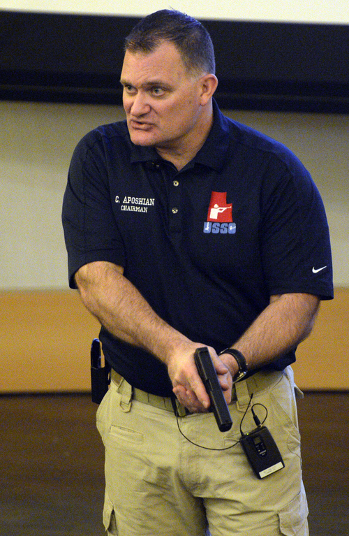Rick Egan  | The Salt Lake Tribune 

Using a plastic gun replica, Clark Aposhian gives instructions during a free concealed firearms permit class to Utah educators at the Salt Lake City Library, Friday, January 3, 2014.