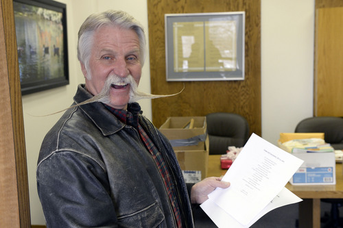 Al Hartmann  |  The Salt Lake Tribune
After four terms (16 years) Dan Snarr with his signature handlebar mustache is leaving his post as mayor of Murray.  He laughs reading a piece of cowboy poetry he's found cleaning out the office at Murray City Hall December 31, 2013.