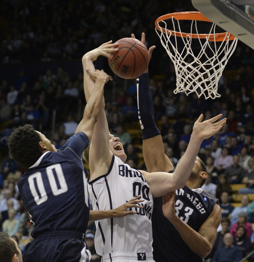 Rick Egan  | The Salt Lake Tribune 

Brigham Young Cougars Eric Mika (00) is double teamed by Christopher Anderson (00) and San Diego forward/center Jito Kok (33), as he goes up for a shot,  in basketball action, BYU vs. The San Diego Toreros at the Marriott Center,  Saturday, January 4, 2014.