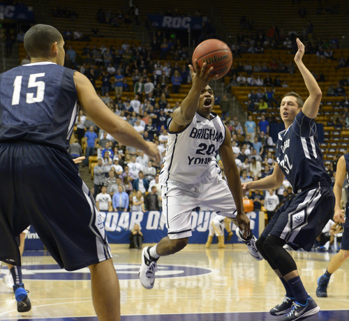 Rick Egan  | The Salt Lake Tribune 

Brigham Young Cougars guard Anson Winder (20) splits defenders, San Diego Toreros forward Thomas Jacobs (15) and San Diego Toreros forward Brett Bailey (32), as he takes the ball inside, in basketball action, BYU vs. The San Diego Toreros at the Marriott Center,  Saturday, January 4, 2014.
