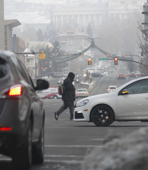 Al Hartmann  |  The Salt Lake Tribune
Commuters go to work in downtown Salt Lake City on Feb. 5, 2013, on a foggy morning with another unhealthy air day for sensitive groups in the forecast.