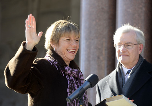Al Hartmann  |  The Salt Lake Tribune
Newly elected city councilwoman Lisa Ramsey Adams takes the oath of office with husband John outside the City-County Building Monday January 6 in Salt Lake City. She was one of four councilmen that were sworn in.
