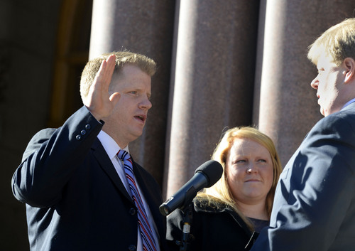 Al Hartmann  |  The Salt Lake Tribune
Newly elected city councilman James Rogers takes the oath of office with wife Megan outside the City-County Building Monday January 6 in Salt Lake City.  He was one of four councilmen that were sworn in.