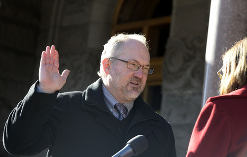 Al Hartmann  |  The Salt Lake Tribune
Newly elected city councilman Stan Penfold takes the oath of office outside the City-County Building Monday January 6 in Salt Lake City.  He was one of four councilmen that were sworn in.