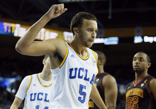 UCLA's Kyle Anderson (5) celebrates after scoring while being fouled by Southern California's Roschon Prince (not shown) as Southern Cal's Byron Wesley, right, looks on during the second half of an NCAA college basketball game on Sunday, Jan. 5, 2014, in Los Angeles. UCLA won 107-73. (AP Photo/Danny Moloshok)