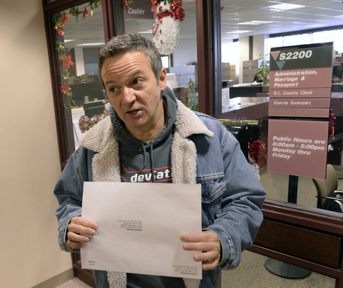 Al Hartmann  |  The Salt Lake Tribune
Michael Braxton, who legally performed a marriage for a same sex couple on Saturday, arrives at the Salt Lake County Clerk' Office Monday Jan. 6, 2014, to register the marriage certificate a few minutes after the Supreme Court issued a stay to Utah's gay marriage ruling. He was a worried that the ruling would affect the legality of the marriage but since it took place before the stay the clerk's office recorded it.