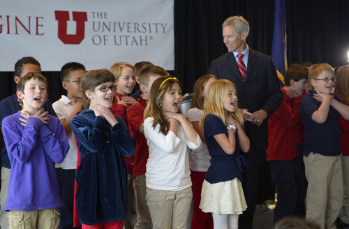 Rick Egan  | The Salt Lake Tribune 

Salt Lake City Mayor Ralph Becker listens to fourth-graders from Whittier Elementary School sing a song about air pollution as part of his 2014 presentation of the State of the City Address in the Varsity Room on the 6th floor of the Rice-Eccles Stadium & Tower, Wednesday, January 8, 2014.