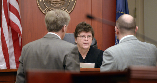 Al Hartmann  |  The Salt Lake Tribune
Defense lawyer Michael Peterson, left,  and prosecuter Robert Parrish confer with Judge Judith Atherton in Salt Lake City Wednesday Jan. 8, 2014 during the murder trial of Esar Met, who is accused of killing 7-year-old Hser Ner Moo, who disappeared on March 31, 2008.