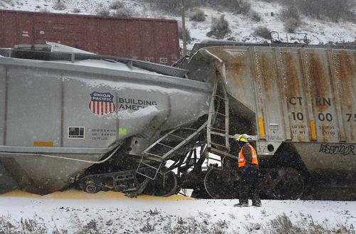 Scott Sommerdorf   |  The Salt Lake Tribune
The scene of a train derailment just off I-84 between Morgan and Ogden. Weber County Sheriffs said two westbound Union Pacific trains were involved in some sort of collision that caused one to derail, Wednesday, January 8, 2014. The cargo of grain can be seen spilled out near where these two cars collided and crumpled.