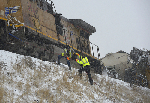 Scott Sommerdorf   |  The Salt Lake Tribune
Union Pacific investigators climb up to the scene of a train derailment just off I-84 between Morgan and Ogden. Weber County Sheriffs said two westbound Union Pacific trains were involved in some sort of collision that caused one to derail, Wednesday, January 8, 2014.