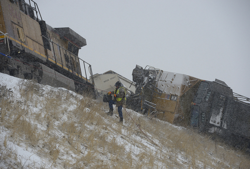 Scott Sommerdorf   |  The Salt Lake Tribune
A Union Pacific investigator climbs up to the scene of a train derailment just off I-84 between Morgan and Ogden. Weber County Sheriffs said two westbound Union Pacific trains were involved in some sort of collision that caused one to derail, Wednesday, January 8, 2014.
