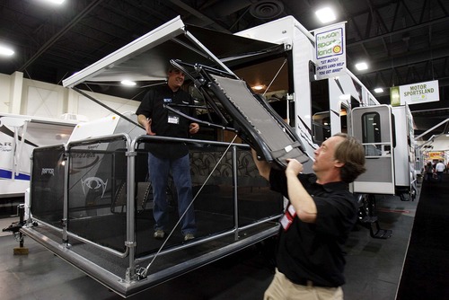 Trent Nelson  |  The Salt Lake Tribune
Mike Neff, left, and Casey Robertson of Motor Sportsland set up chairs on the back deck of an recreational vehicle at the Utah RV Show held at the South Towne Expo Center in Sandy on Thursday, Feb. 17, 2011.