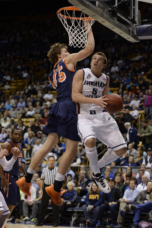 Francisco Kjolseth  |  The Salt Lake Tribune
Pepperdine Waves forward Jett Raines (45) tries to block Brigham Young Cougars guard Kyle Collinsworth (5) as he goes underneath in game action at the Marriott Center in Provo on Thursday, Jan. 9, 2014.