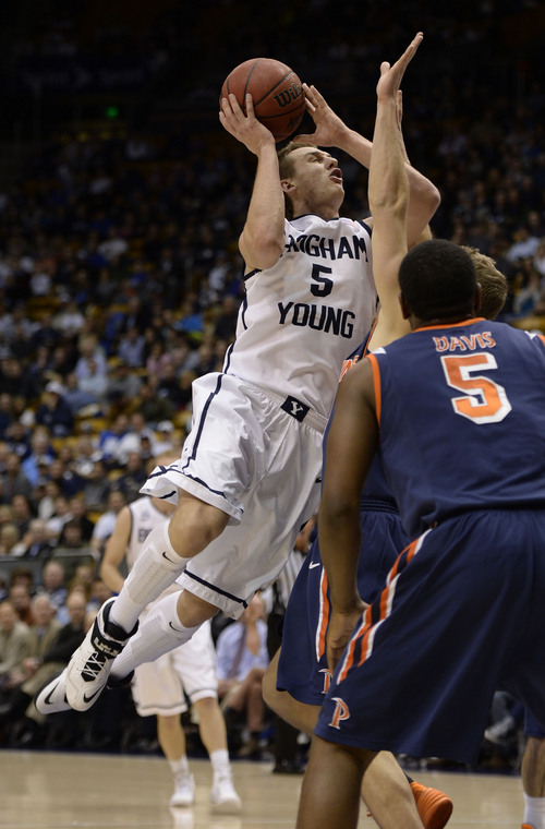 Francisco Kjolseth  |  The Salt Lake Tribune
Brigham Young Cougars guard Kyle Collinsworth (5) drives one to the basket in game action against Pepperdine at the Marriott Center in Provo on Thursday, Jan. 9, 2014.