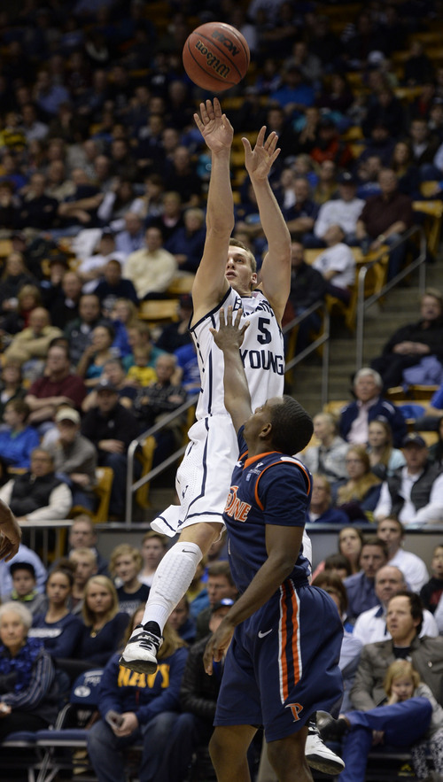 Francisco Kjolseth  |  The Salt Lake Tribune
Brigham Young Cougars guard Kyle Collinsworth (5) gets in a three pointer past Pepperdine Waves guard Jeremy Major (3) in game action at the Marriott Center in Provo on Thursday, Jan. 9, 2014.