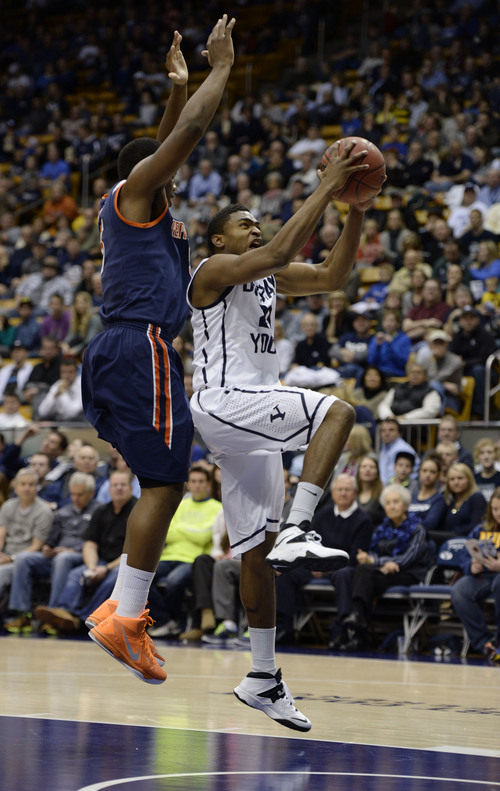 Francisco Kjolseth  |  The Salt Lake Tribune
Pepperdine Waves forward Stacy Davis (5) tries to block Brigham Young Cougars guard Anson Winder (20) in game action at the Marriott Center in Provo on Thursday, Jan. 9, 2014.