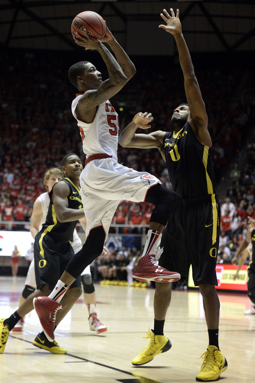 Francisco Kjolseth  |  The Salt Lake Tribune
Utah Utes guard Delon Wright (55) sneaks one in to give the Utes a little bit of hope before being shut down by Oregon 70 to 68 in game action at the Hunstman Center on the University of Utah campus on Thursday, Jan. 2, 2014.