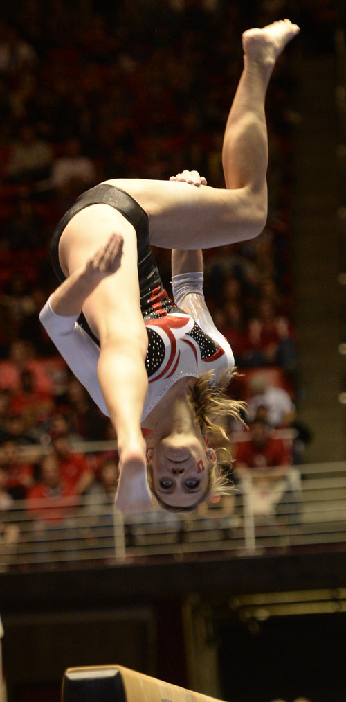 Rick Egan  | The Salt Lake Tribune 

Mary Beth Lofgren competes on the bars for the Utes, in their Gymnastics opener, Utah vs, BYU, Boise State and Southern Utah University,  at the Huntsman Center, Friday, January 10, 2014.