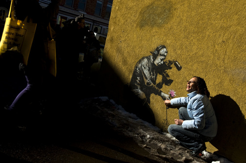 Chris Detrick  |  The Salt Lake Tribune 
Festivalgoers take a picture next to a Banksy art work during the Sundance Film Festival in Park City Friday January 21, 2011.