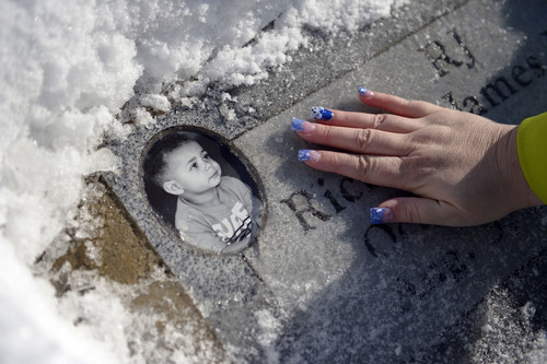 Francisco Kjolseth  |  The Salt Lake Tribune
Sequoia Moore who lost her 22-month-old son in a motorcycle accident when the child was thrown from the bike, which he had been riding with his father visits her sons grave in Taylorsville wearing the snowy polar bear on her nails like the stuffed toy he was burried with. The baby was not wearing a helmet and was seated in between the handle bars. He died on impact. In the almost-two-years since, Sequoia has endured losing her child, ending her marriage and watching her ex-husband be criminally charged with her son's death. He was convicted last month of child abuse homicide and faces up to 15 years in prison.