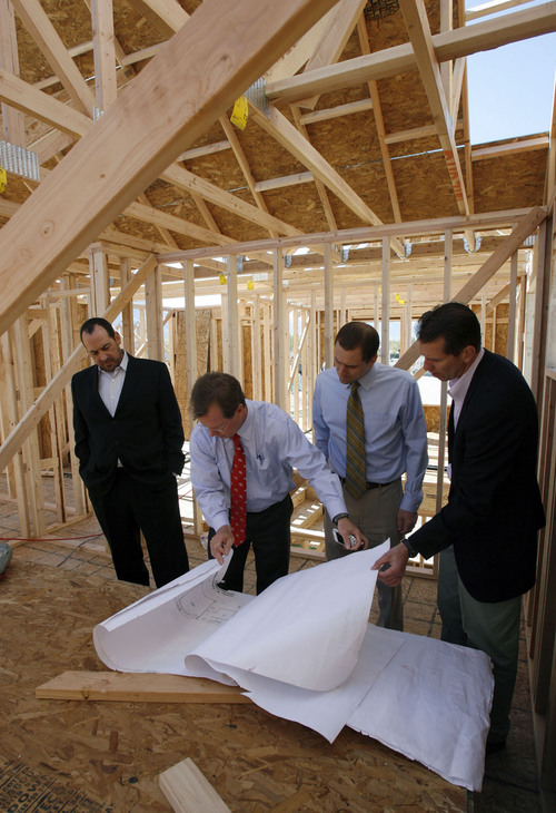 Francisco Kjolseth  |  The Salt Lake Tribune
Clark Ivory, second from left, CEO of Ivory Homes, the biggest homebuilder in Utah, overlooks plans on a new home being built in Stansbury Park along with Christopher Gamvroulas, president of Ivory development, CFO Rick Lifferth and Jim Seaberg, president of Ivory Commercial, from left. Ivory Homes has completed 15,000 houses over the years. It's been the top homebuilder in the state for at least 23 years and has been hugely influential in how homes in northern Utah look.