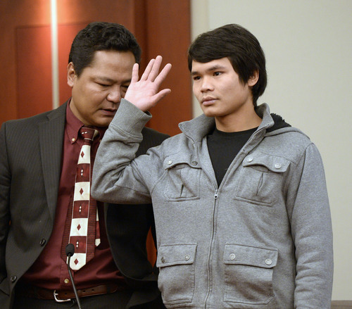 Al Hartmann  |  The Salt Lake Tribune
Maung Myo Mye who shared an apartment unit with Esar Met is sworn in to testify in Judge Judith Atherton's courtroom in Salt Lake City Tuesday January 14, 2014. A court interpreter is at left. Esar Met is accused of killing 7-year-old Hser Ner Moo, who disappeared on March 31, 2008.