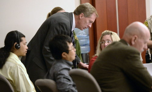 Al Hartmann  |  The Salt Lake Tribune
Defense lawyer Michael Peterson, center, talks with members of the defense team Denise Porter and John West during Esar Met's murder trial in Salt Lake City Wednesday January 15, 2014.  The defense asked Judge Judith Atherton to declare a mistrial when new possible blood evidence was introduced. Esar Met is accused of killing 7-year-old Hser Ner Moo, who disappeared on March 31, 2008.