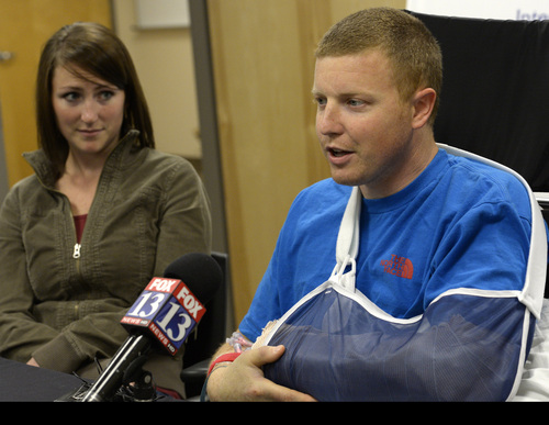 Rick Egan  | The Salt Lake Tribune 

Emilee Morgan looks on as her husband Matt Morgan, admits he is not scared to once again ride his snow mobile on high-risk avalanche days after he recovers, during a press conference at the McKay-Dee Hospital, Wednesday, January 15, 2014. Morgan survived the avalanche near the Idaho-Utah border on Saturday,