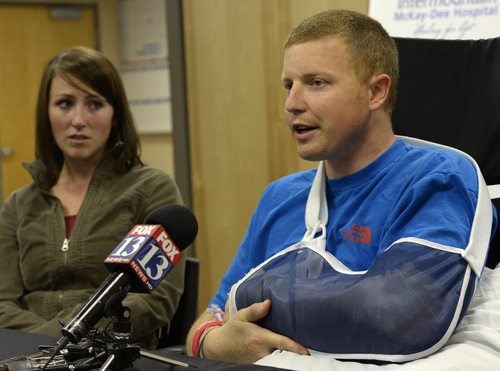 Rick Egan  | The Salt Lake Tribune 

Emilee Morgan looks on as her husband Matt Morgan, admits he is not scared to once again ride his snow mobile on high-risk avalanche days after he recovers, during a press conference at the McKay-Dee Hospital, Wednesday, January 15, 2014. Morgan survived the avalanche near the Idaho-Utah border on Saturday,