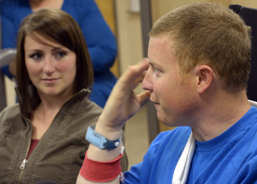 Rick Egan  | The Salt Lake Tribune 

Emilee Morgan (left) listens as her husband, Matt Morgan, talks about how he survived an avalanche near the Idaho-Utah border on Saturday, during a press conference at the McKay-Dee Hospital, Wednesday, January 15, 2014.