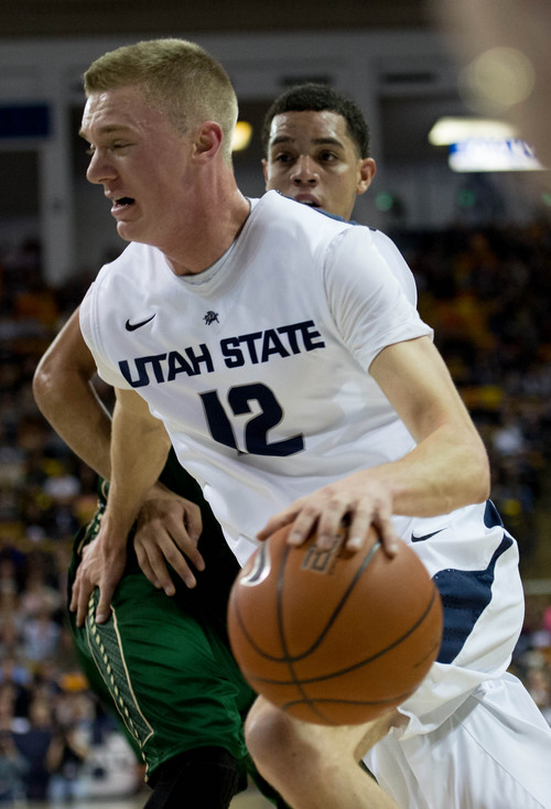 Trent Nelson  |  The Salt Lake Tribune
Utah State Aggies guard/forward Danny Berger (12) drives to the basket, with Colorado State Rams guard Daniel Bejarano (2) defending, as Utah State University hosts Colorado State, NCAA basketball, Wednesday January 15, 2014 in Logan.