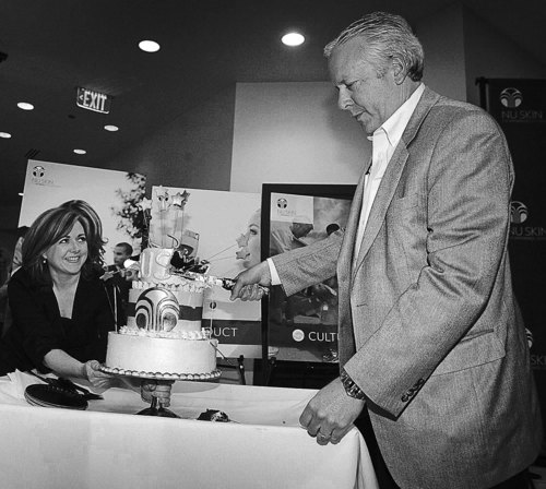 Paul Fraughton  |  The Salt Lake Tribune
As Jordan Karpowitz steadies the plate, Blake Roney, who started the beauty products company NuSkin, slices into a  cake commemorating its 25th year in business. The celebration took place at the company's Provo headquarters on Tuesday,  June 9, 2009 .