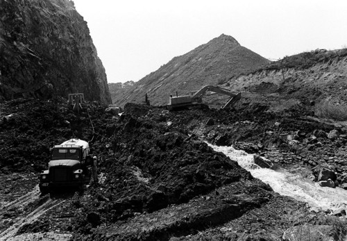 Spanish Fork Canyon in Utah County, Utah on April 15, 1983. Photo by Salt Lake Tribune photographer Lynn R. Johnson. The text of this story:
Spanish Fork Canyon was closed early Friday as the mountain near Thistle Junction continued to move, raising U.S. 6, the Spanish Fork River bed and the Denver and Rio Grande Western railroad tracks. L.R. Jester, district six director for the Utah Department of Transportation, said the highway was closed to traffic at 1:30 a.m. Railway and highway crews have been working since Thursday to try to stop the damage; however, efforts to this point have been futile because the highway is being pushed up due to pressure from a nearby slide. Jester said four big big backhoes are taking dirt from the adjacent Spanish Fork River in an effort to keep the channel open and prevent flooding.