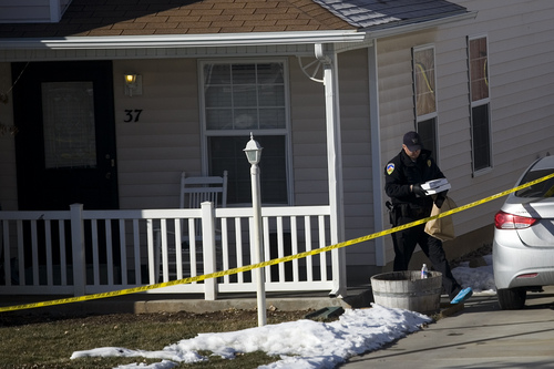 Investigators remove evidence from a home, Friday, Jan. 17, 2014, in Spanish Fork, Utah,  where five people were found dead on Thursday.  A 34-year-old officer shot and killed his wife, mother-in-law and two young children and turned the gun on himself, authorities said Friday.  Spanish Fork police said the five were found dead about 11 p.m. Thursday, when co-workers reported Joshua Boren didn't show up for his night shift as a patrol officer at the Lindon Police Department. (AP Photo/Daily Herald, Mark Johnston)