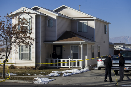 Investigators put police tape in front of a home, Friday, Jan. 17, 2014, in Spanish Fork, Utah, where five people were found dead on Thursday.  A 34-year-old officer shot and killed his wife, mother-in-law and two young children and turned the gun on himself, authorities said Friday.  Spanish Fork police said the five were found dead about 11 p.m. Thursday, when co-workers reported Joshua Boren didn't show up for his night shift as a patrol officer at the Lindon Police Department. (AP Photo/Daily Herald, Mark Johnston)