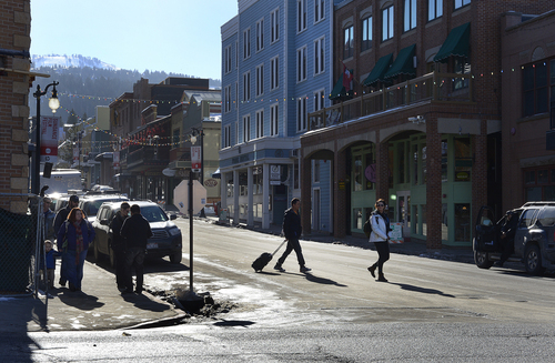 Scott Sommerdorf   |  The Salt Lake Tribune
Visitor cross the street at Heber and Main in Park City, Wednesday, January 15, 2014.