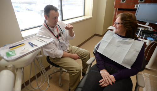 Steve Griffin  |  The Salt Lake Tribune

Dentist Ron Kehl talks with patient Mary Hogle-Jahn about her teeth at the new 4th Street Dental Clinic in Salt Lake City, Friday, January 17, 2014.